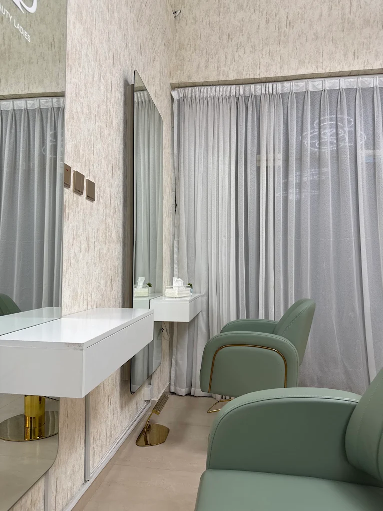 Salon chair beside mirror and soft curtains